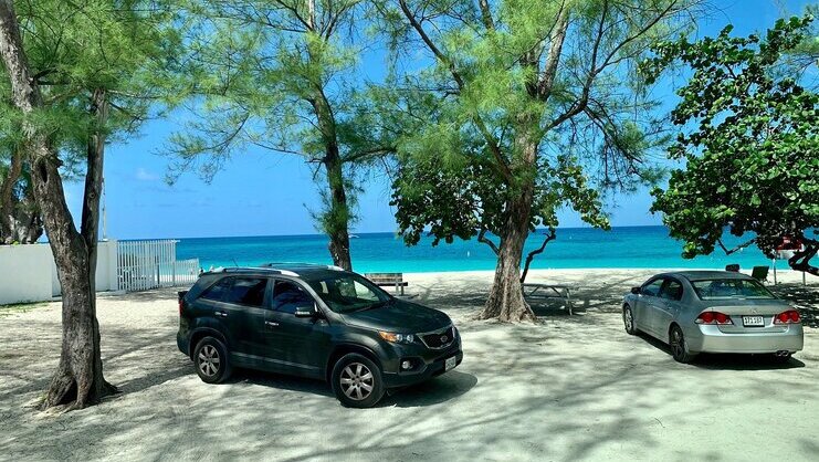 picture of two cars with beach in background