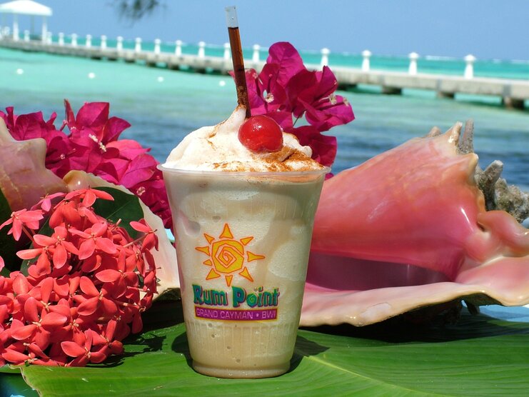 picture of a mudslide drink on a table with sea in background